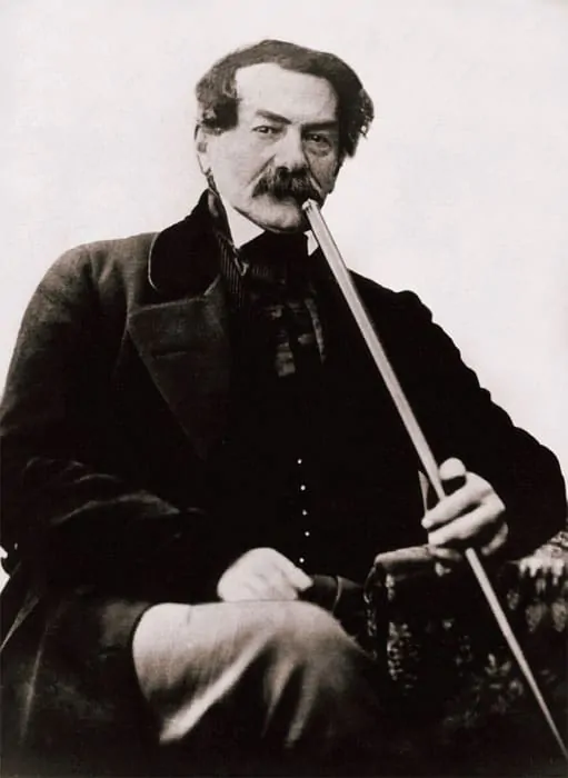 Portrait of an early Russian photographer holding a long smoking pipe