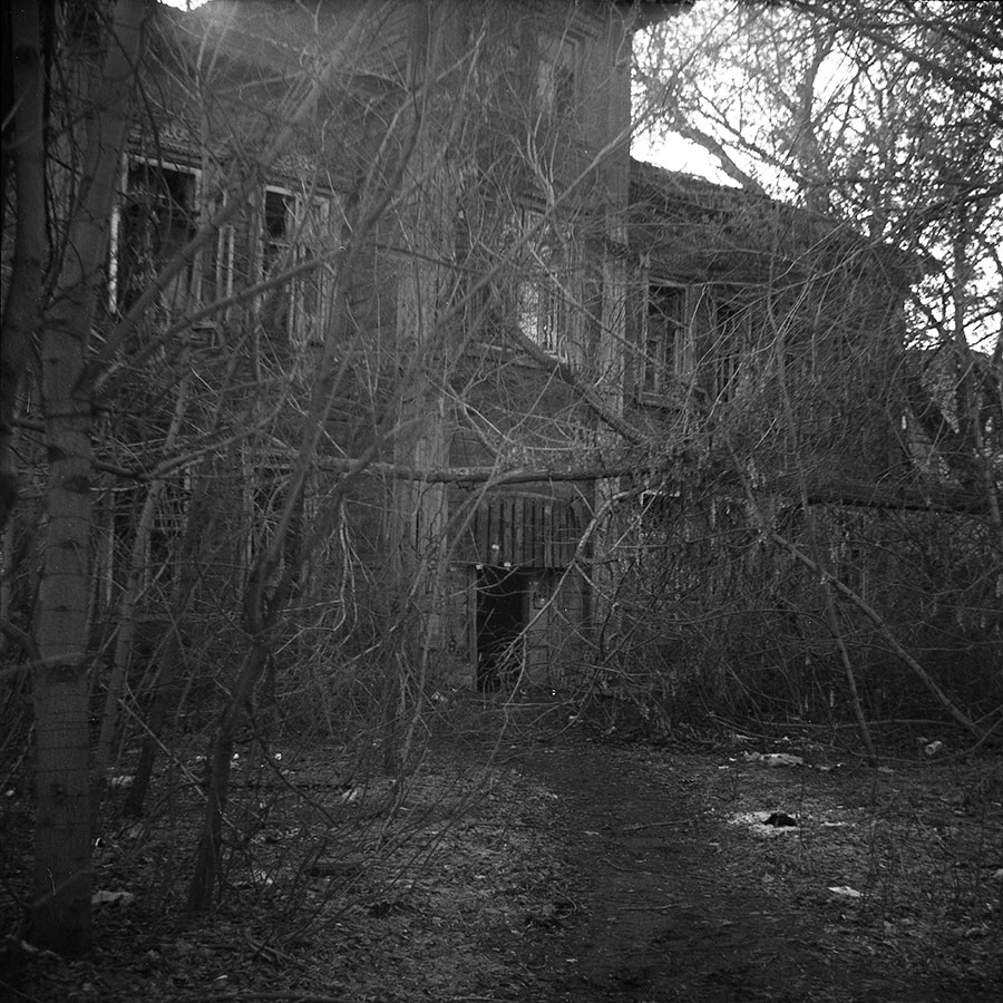 6x6 film photo of abandoned wooden house