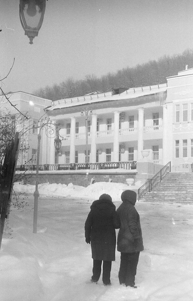 Sport camera sample photo of persons walking in snow, vintage film effect