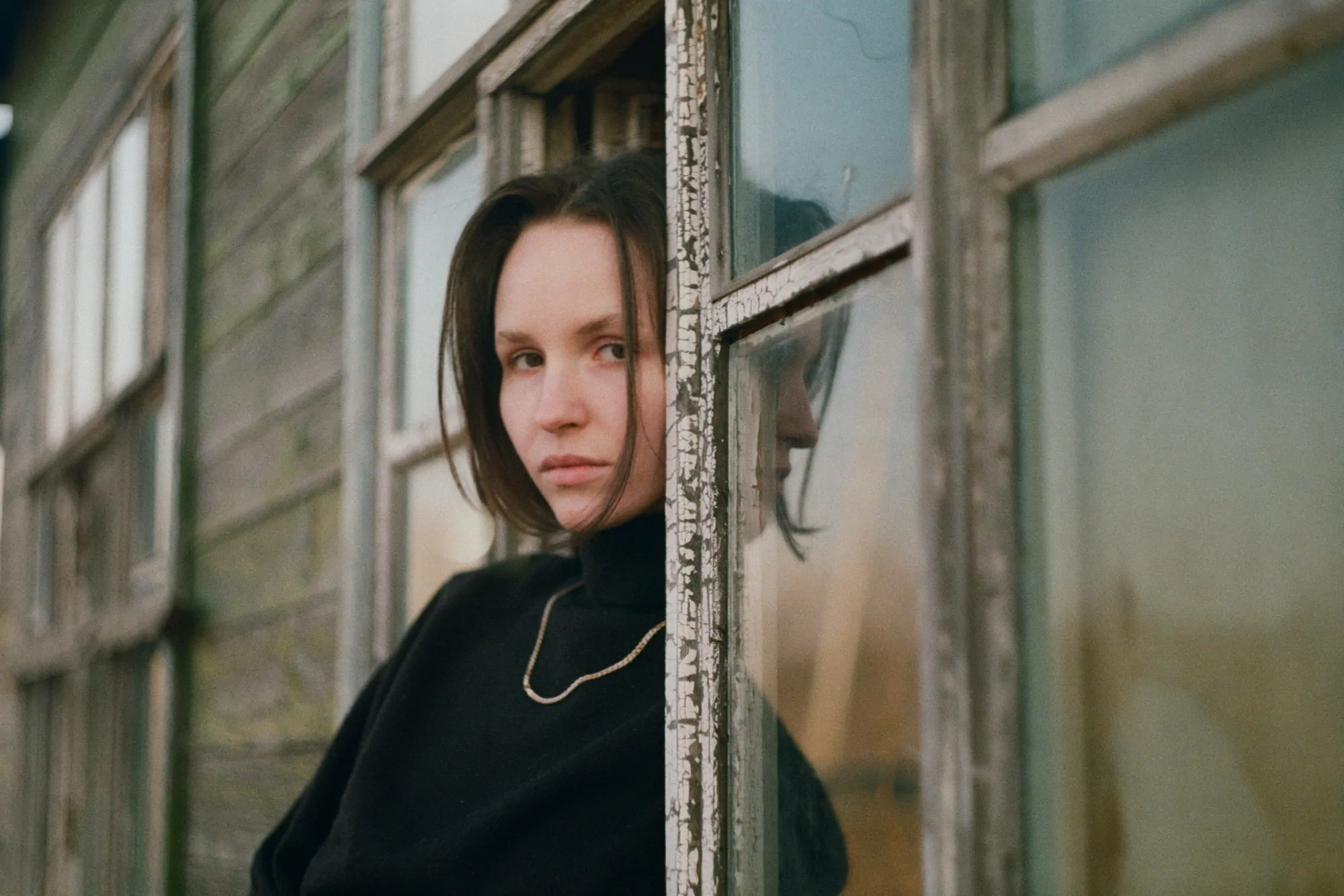 Woman and old house shot on a helios 44 start lens