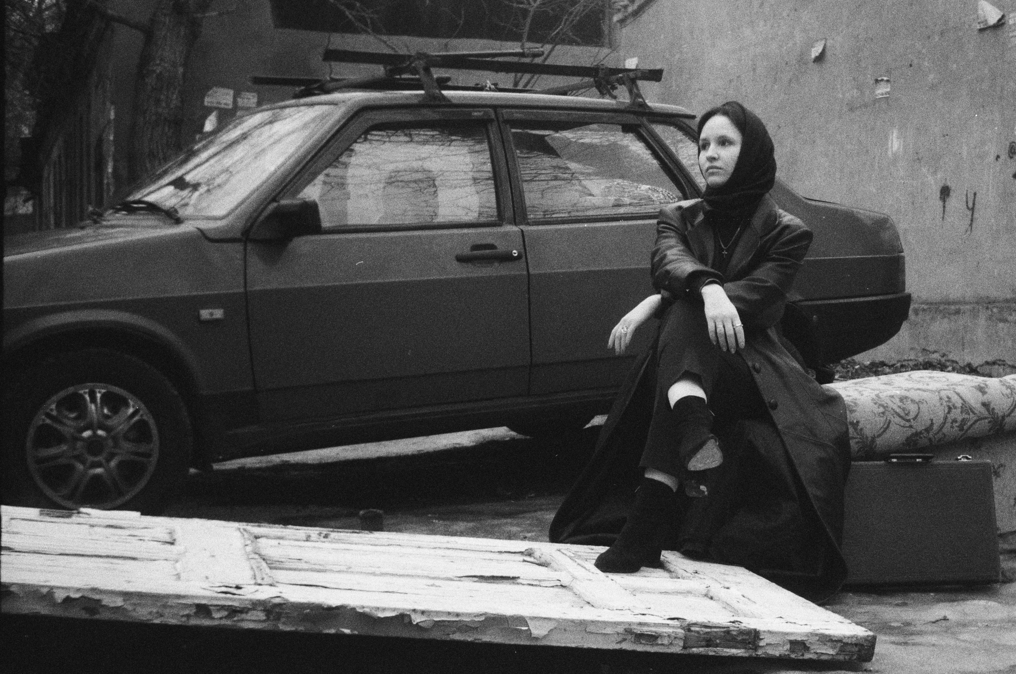 Woman in authentic clothes and an old lada car shot on a triplet t-22 lens